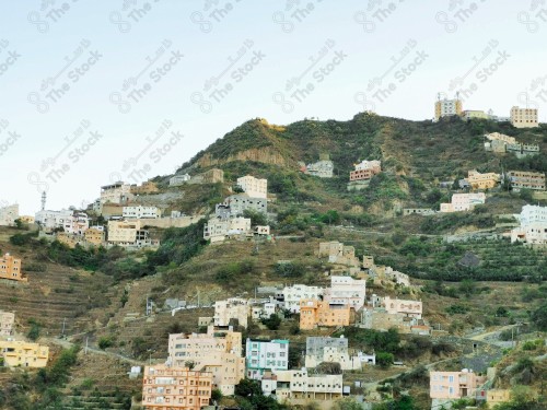 A phone shot shows a group of houses in the middle of the mountains and forests of the Fayfa Governorate in the Jazan region of Saudi Arabia. trees and forests