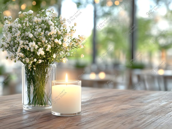 A lit candle and white flowers on a wooden table in a bright restaurant; perfect for blogs, websites, or home decor magazines