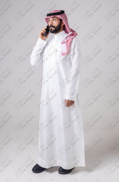 Portrait of a Saudi man holding a phone and making a phone call with different expressions