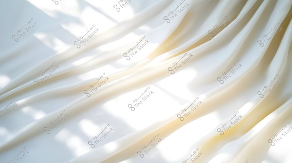 An image of waves of white fabric in sunlight, creating beautiful shadow effects on the surface. The fabric features soft folds and subtle light reflections, evoking a sense of calm and comfort.