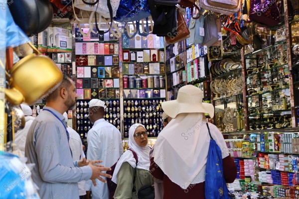 Mecca, Saudi Arabia - March 12 2025: people buying products from market shop in Mecca close to Masjid al-Haram, pilgrims umrah shopping in Makkah