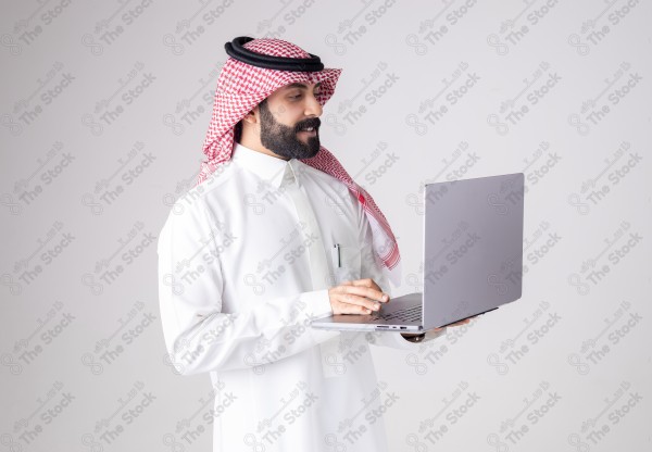 Portrait of a Saudi man holding a laptop and making different expressions, customer service, and communication.