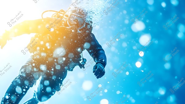 Image of a diver underwater wearing full diving gear, heading towards the surface with bright sunlight streaming through. Bubbles are visible in the water, adding a sense of motion and liveliness. The diver is wearing a mask and protective suit.