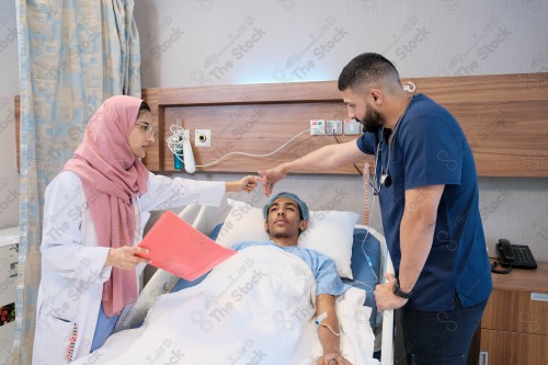 Saudi female doctor and paramedic in medical uniform and examining and applying nutritional solution, medicine and health care