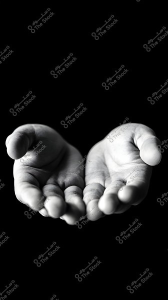 An image of open hands in black and white against a black background, highlighting the fine details and skin lines resulting from hand movement. The hands are bare and appear in a state of waiting or receiving.