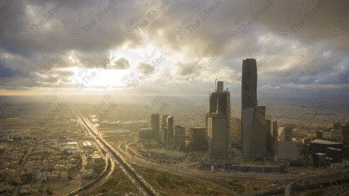 An aerial shot of the towers of the King Abdullah Financial District, showing the buildings and landmarks of the city of Riyadh in the daytime at sunset.