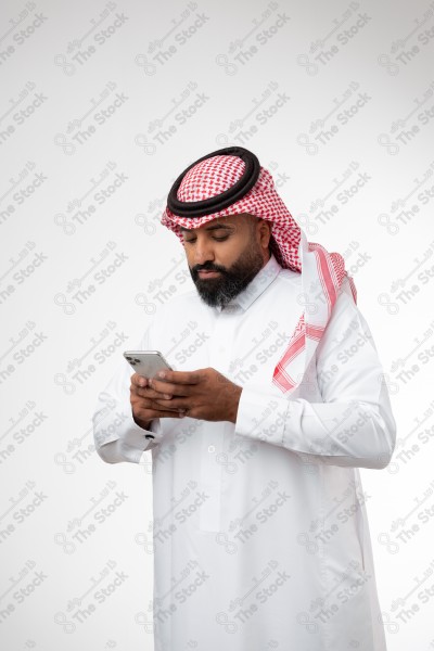 Portrait of a Saudi man holding a phone and making different expressions, white background