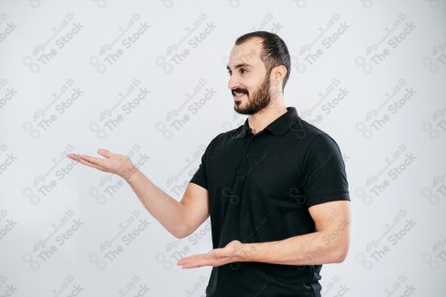 Portrait of a Saudi man on a white background making hand gestures while smiling, souvenir photos, documenting a happy moment