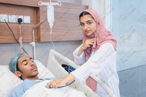 A Saudi female doctor wears a medical uniform and is examining and applying a nutrient solution, medicine and health care