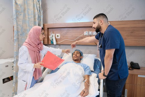 Saudi female doctor and paramedic in medical uniform and examining and applying nutritional solution, medicine and health care