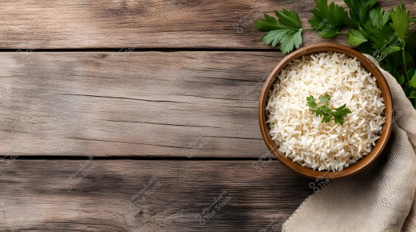 A bowl of white rice in a wooden bowl placed on a dark wooden table. The dish is garnished with some parsley leaves and accompanied by a piece of linen cloth with more parsley leaves scattered on the table.