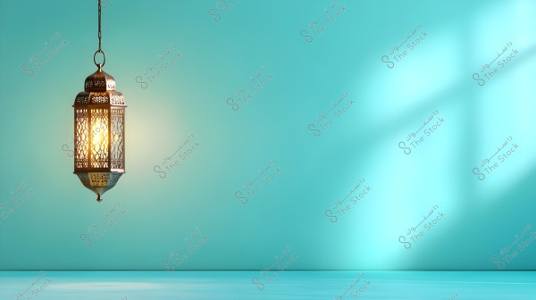 An image of a traditional lantern illuminated in golden light hanging against a light blue wall. The lantern features intricate designs that cast reflections on the wall behind it, creating an aesthetically pleasing effect. The light emitted from the lantern provides a sense of warmth and tranquility.