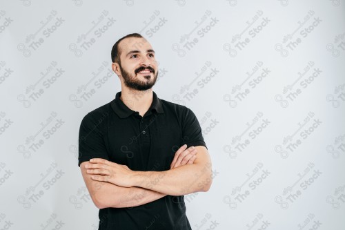 Portrait of a Saudi man on a white background making hand gestures while smiling, souvenir photos, documenting a happy moment