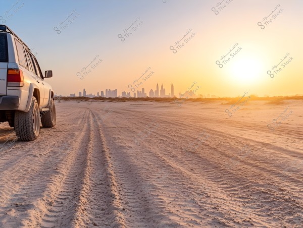 A four-wheel drive vehicle stands on the desert sands, with the sunset on the horizon. The skyline of a modern city is clearly visible in the background, casting shadows of tall buildings against the orange sky.