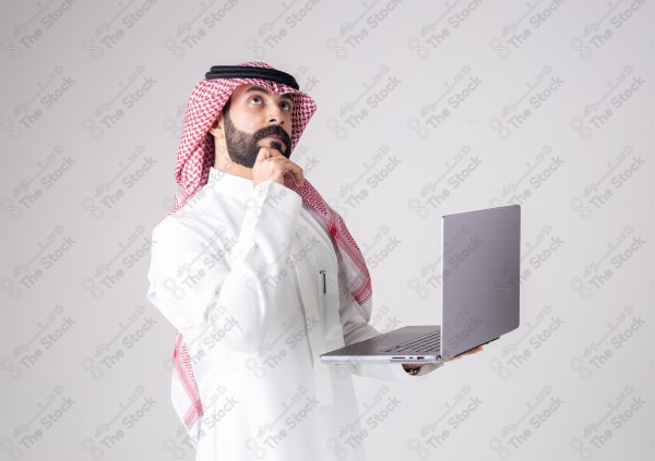 Portrait of a Saudi man holding a laptop and making different expressions, customer service, and communication.