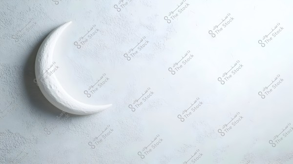 The image shows a 3D crescent moon in white, attached to a light gray wall with a smooth texture. The background is soft and illuminated.