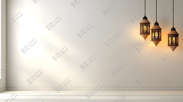 The image shows three traditional hanging lanterns against a white wall. The lanterns are lit, casting a warm glow that reflects across the empty wall space, creating a calm and minimalist atmosphere.