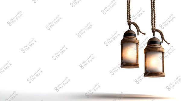 Two illuminated wooden lanterns hanging by jute ropes against a white background. The warm light from the lanterns creates a cozy and tranquil atmosphere, giving a sense of tradition and warmth.