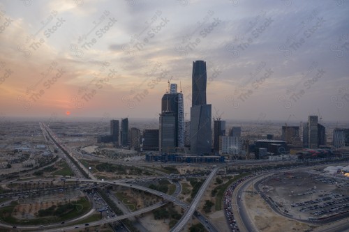 An aerial shot of the towers of the King Abdullah Financial District, showing the buildings and landmarks of the city of Riyadh in the daytime at sunset.