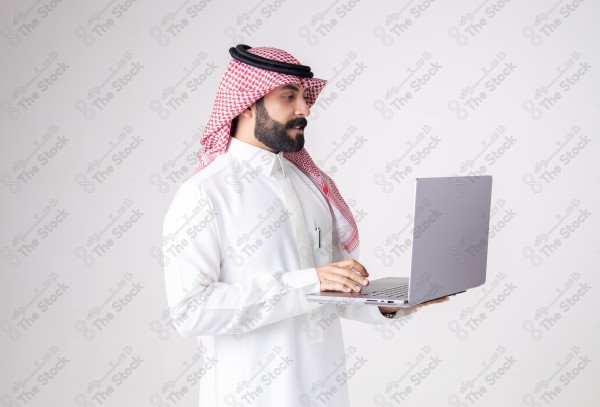 Portrait of a Saudi man holding a laptop and making different expressions, customer service, and communication.