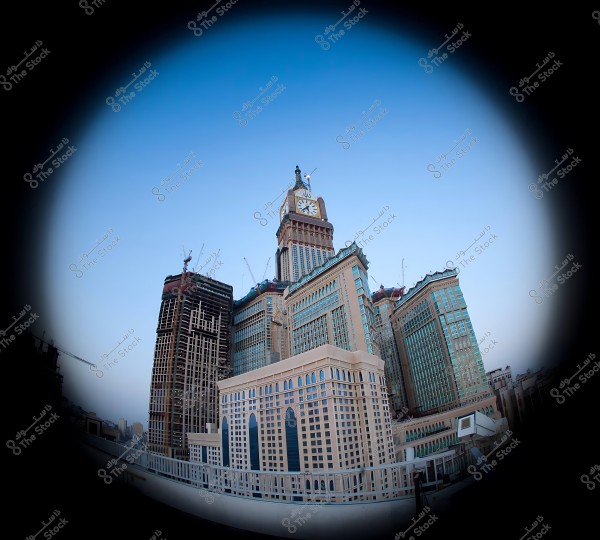 View of the Abraj Al-Bait Towers in Mecca with the large Mecca Clock in the center at sunset.