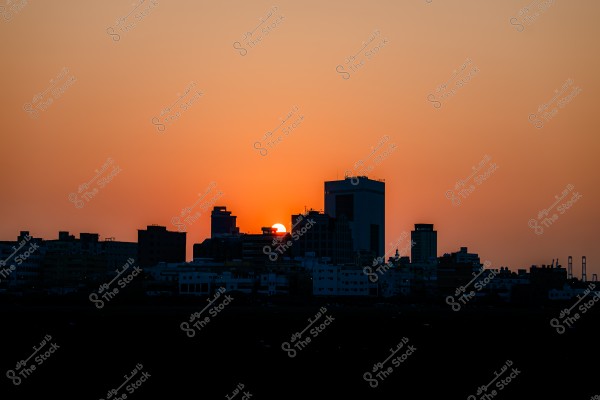 City skyline with the sunset behind the buildings.