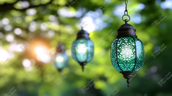 The image shows ornate green glass lanterns, hanging and illuminated in an outdoor natural setting. The lanterns feature intricate designs, and the background displays a bokeh effect with sunlight sparkling through tree leaves.