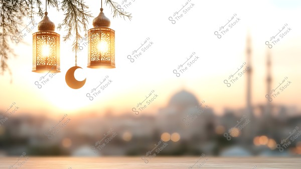 A sunset scene features two illuminated lanterns hanging from a tree branch with a metallic crescent nearby. In the background, mosque minarets are visible, creating a peaceful Middle Eastern ambiance.