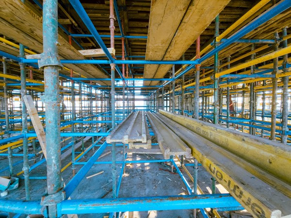 A construction site with a large building in the background. multi-storey building. A construction site with scaffolding and a large building in the background.