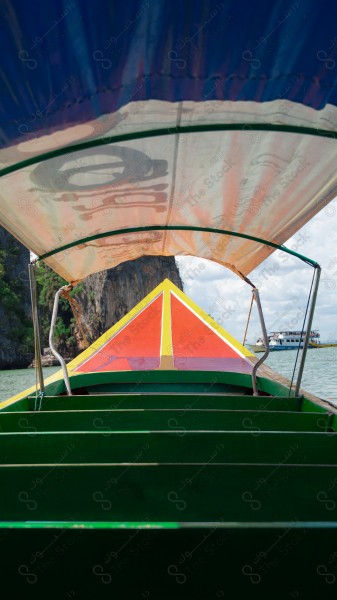 Aesthetic shot from inside a boat on James Bond Island in the Thailand region and the sky appears cloudy during the day, nature in Thailand, island, mountains