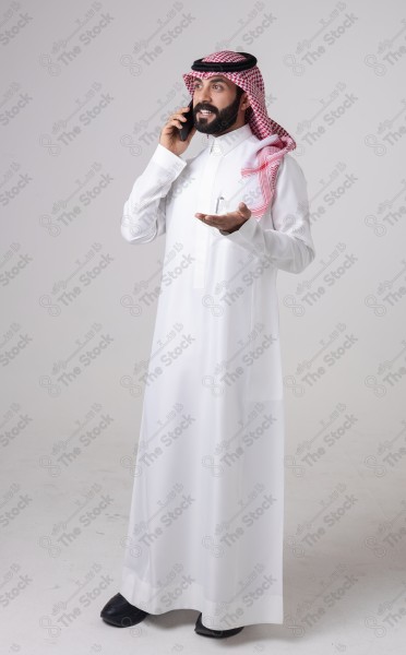 Portrait of a Saudi man holding a phone and making a phone call with different expressions