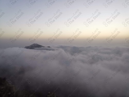 Aerial shot from the top of the mountain، of clouds embracing mountains. Fayfa Governorate, Jazan region, Saudi Arabia.