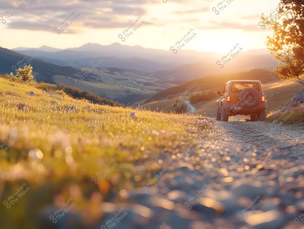 A car driving on a rugged mountain path at sunset. The view shows mountains in the sunlit background and grassy fields on either side of the road. Nearby trees and the distant scene are bathed in golden sunlight, giving the scene a sense of tranquility and natural beauty.