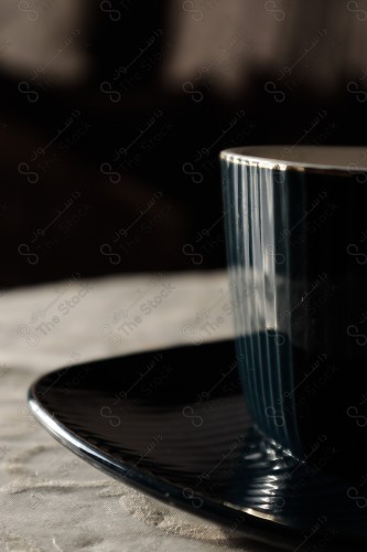 Close-up of a cup of tea on a turquoise plate