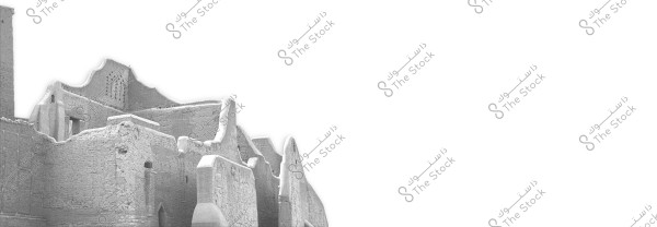 An image showing part of a traditional mud building with distinctive architectural features. The structure has wavy shapes and thick walls, reflecting the old architectural style found in some Arab regions, possibly in Saudi Arabia.