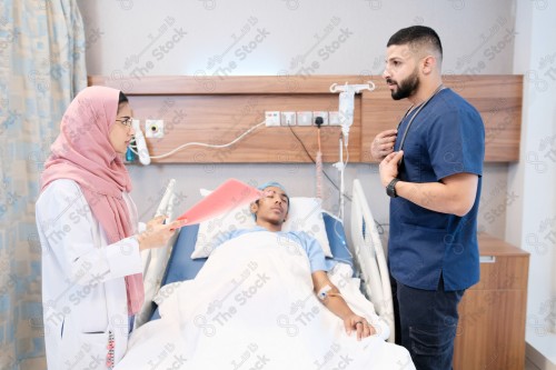 Saudi female doctor and paramedic in medical uniform and examining and applying nutritional solution, medicine and health care