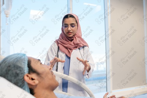 A Saudi female doctor wears a medical uniform and is examining and applying a nutrient solution, medicine and health care