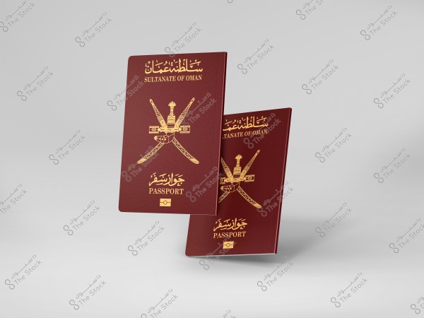 An image of passports featuring the emblem of the Sultanate of Oman written in both Arabic and English. The cover displays a golden emblem of crossed swords and an Omani dagger, symbolizing national identity. The background is a light gray color.