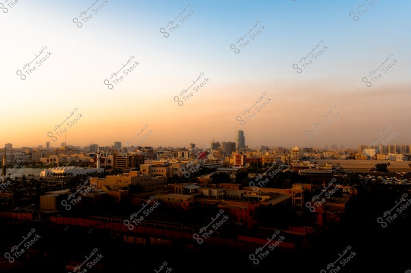 A view of the city of Jeddah with buildings and urban landscape at sunrise or sunset, with a clear horizon.
