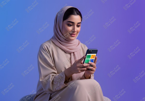A portrait of a woman wearing a light beige hijab and abaya, sitting on a chair while looking at her mobile phone. She is focused on the screen displaying colorful apps. The background is a gradient of blue and purple, giving the image a modern feel.