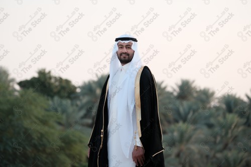 A young Saudi man wears the traditional Saudi dress in a traditional house