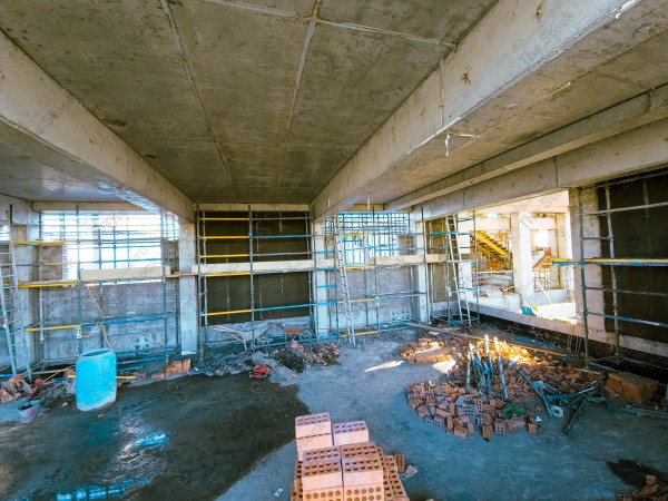 A construction site with a large building in the background. multi-storey building. A construction site with scaffolding and a large building in the background.