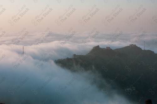 A snapshot showing the Black Mountain in the Jazan region in the south of the Kingdom of Saudi Arabia, an electrifying pillar among the clouds, historical and tourist landmarks, mountainous heights, Jazan mountains, mountainous nature in Jazan