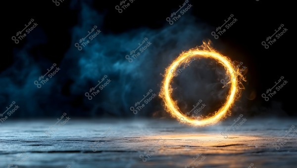 An image shows a flaming ring glowing in the center, composed of yellow and orange flames. The background is dark with blue smoke effects, creating a dramatic and mysterious atmosphere. The ground reflects the fire\'s glow, adding depth to the scene.