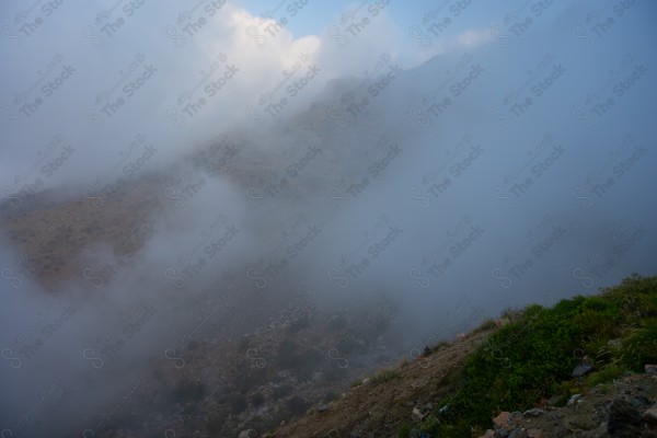 Fog passing over the mountainside from Al Hada, Taif, Saudi Arabia, in winter