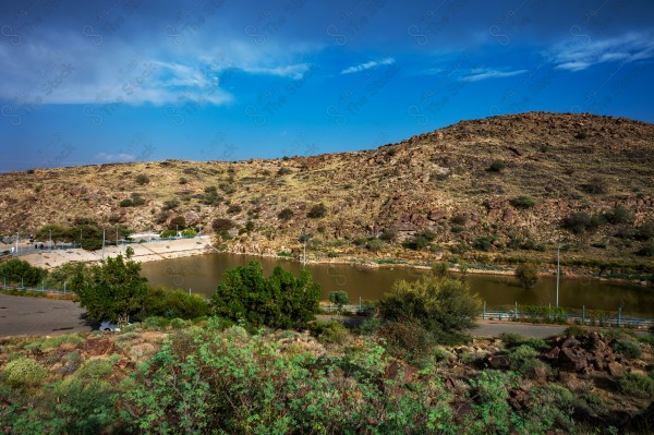 A beautiful view of the Saiysdam Dam surrounded by trees in the Taif region, collecting rainwater, nature in Saudi Arabia