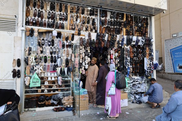 Mecca, Saudi Arabia - March 12 2025: people buying products from market shop in Mecca close to Masjid al-Haram, pilgrims umrah shopping in Makkah