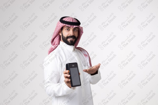 Portrait of a Saudi man holding an automatic payment device and making different expressions