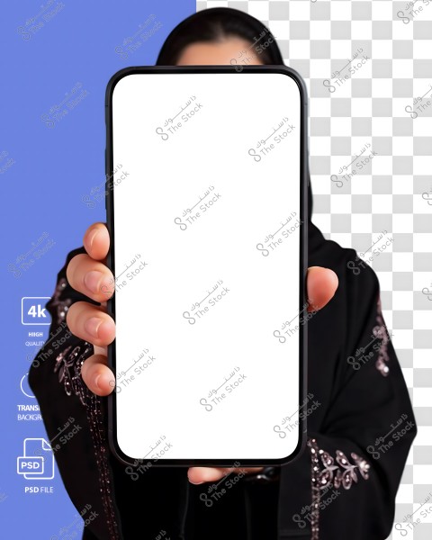 Image of a woman wearing an embroidered black abaya, holding a smartphone with a blank white screen, her face is not visible. The background consists of half blue and half with a checkerboard pattern, indicating a transparent background.