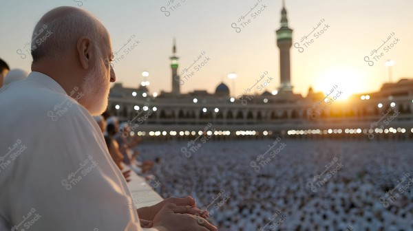 The image shows an elderly man in white Ihram clothing facing the Kaaba in Mecca during sunset. The scene conveys tranquility and serenity as a large crowd of pilgrims gathers around the sacred site. The minarets and the Grand Mosque are visible in the background, while the city\'s lights glitter in the evening.